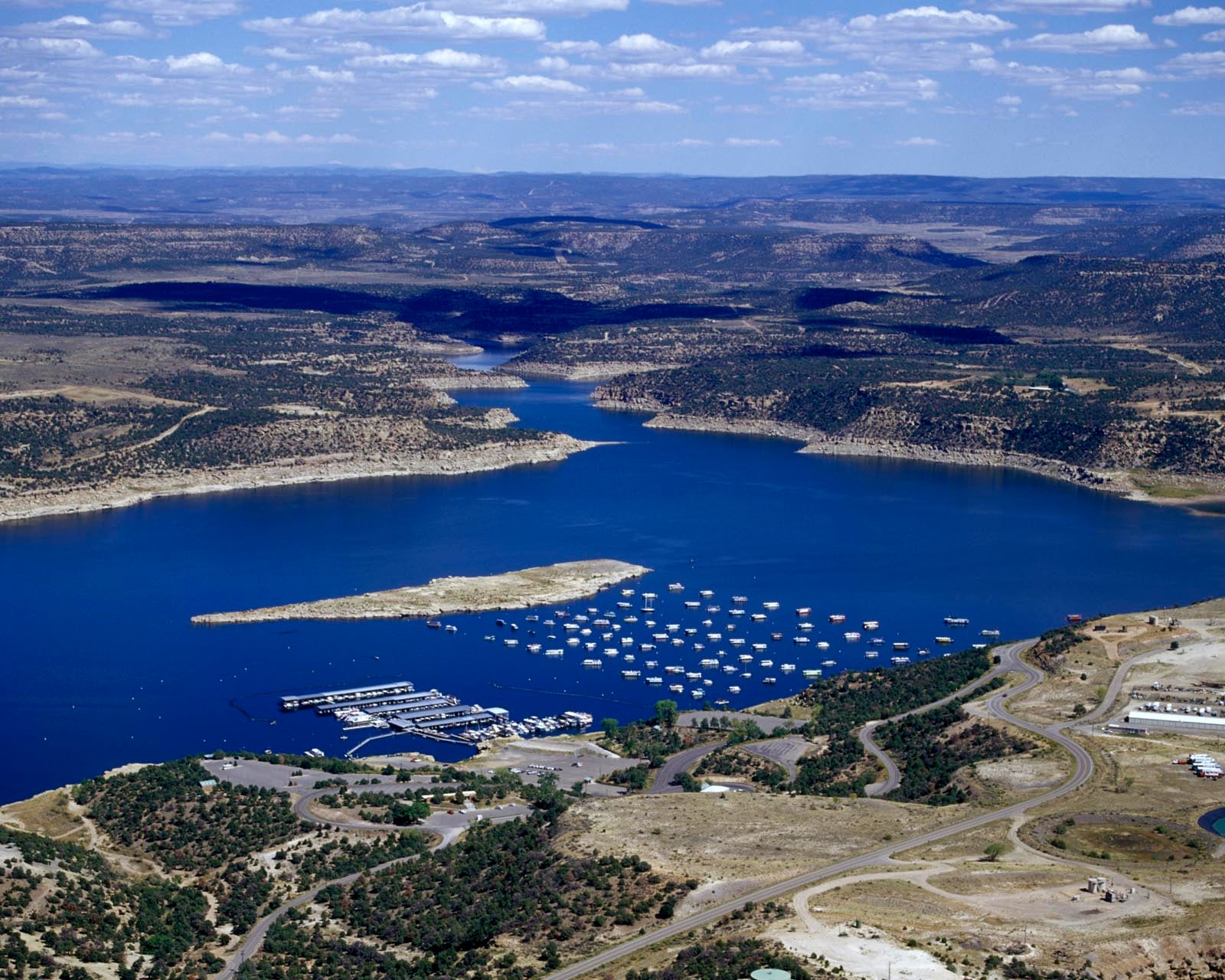 Navajo Lake State Park with blue water surrounded by pine-covered hills in San Juan County New Mexico