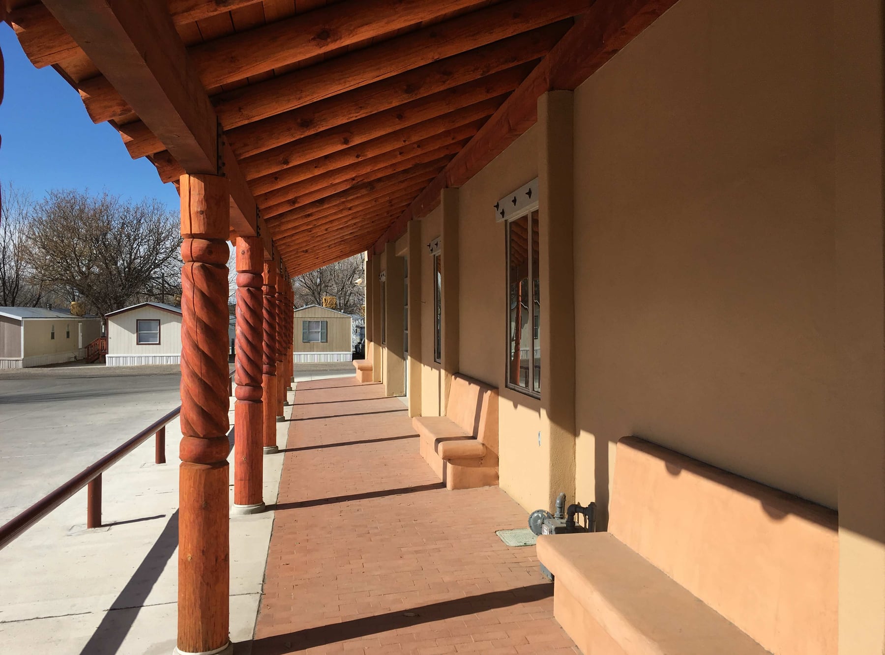 Sundowner Mobile Home and RV Park in Farmington New Mexico with RVs on shaded gravel pads and mature trees